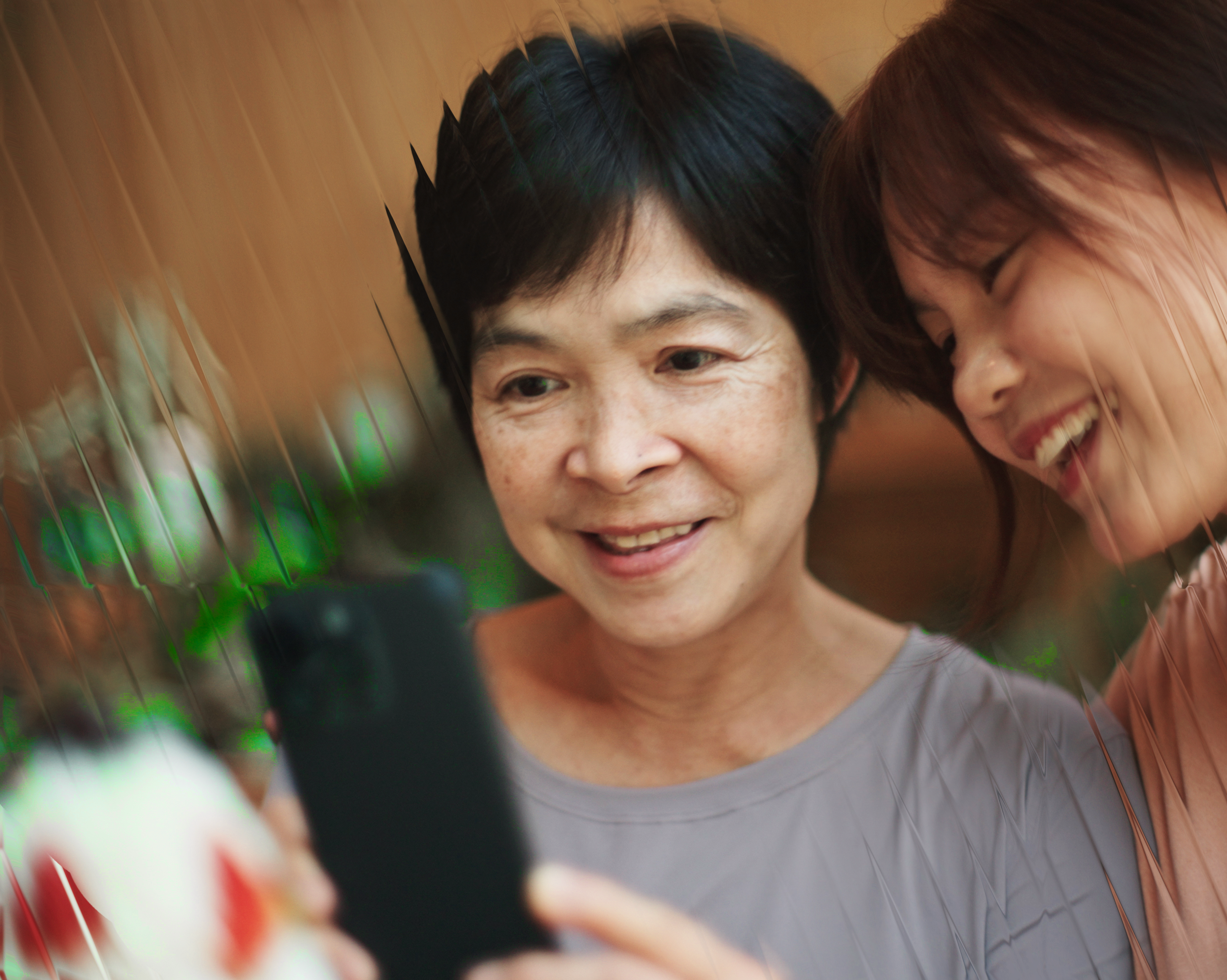 Mum and daughter look at phone 2