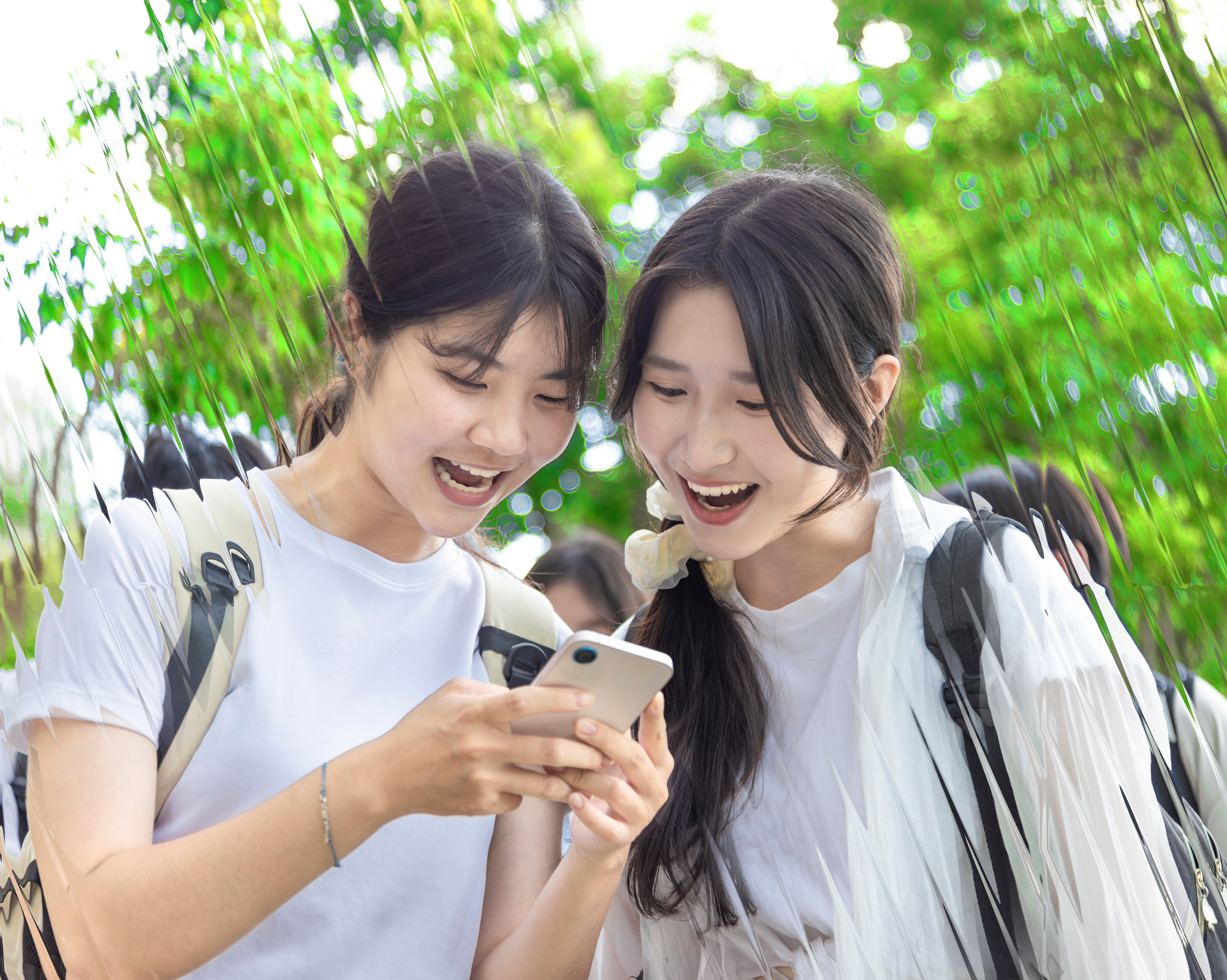 Two white tee students excited at phone